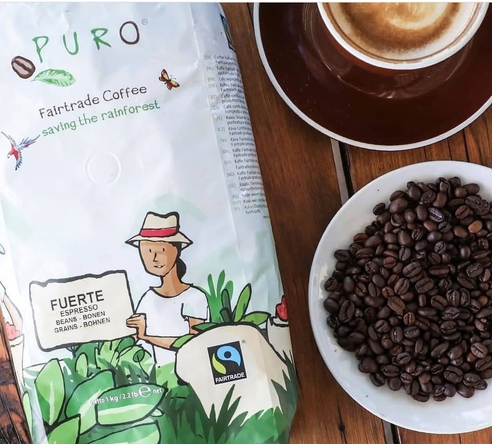 A bag of Puro coffee with beans and a cup