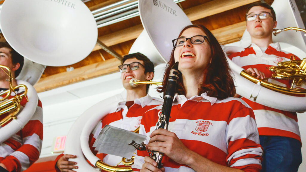 Pep Band members—a clarinetist and sousaphone players—are shown during an October 2023 men's hockey game