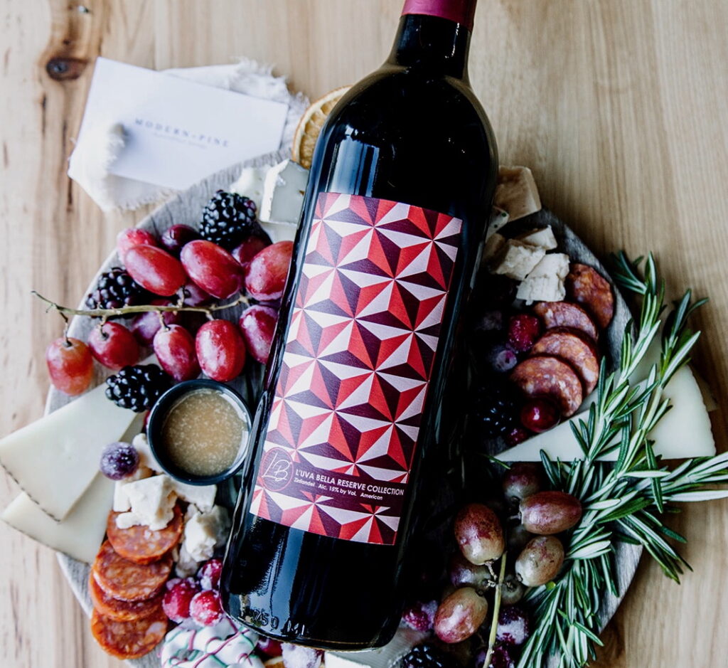 bottle of Luva Bella Winery wine on a holiday themed charcuterie plate
