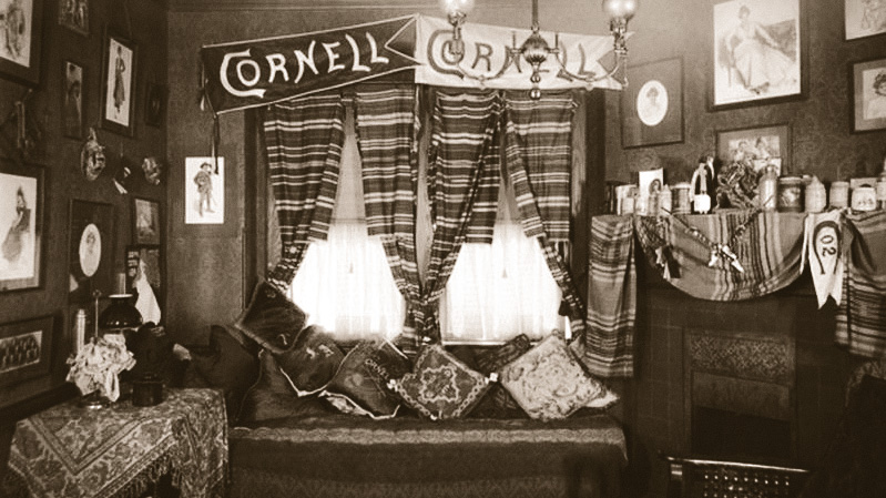 a decorated Cornell dorm room in 1902 includes two Cornell "fishtail" style pennants on the wall