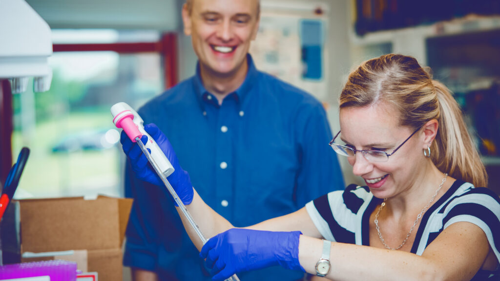 Dr. Alex Travis in the lab with a colleague