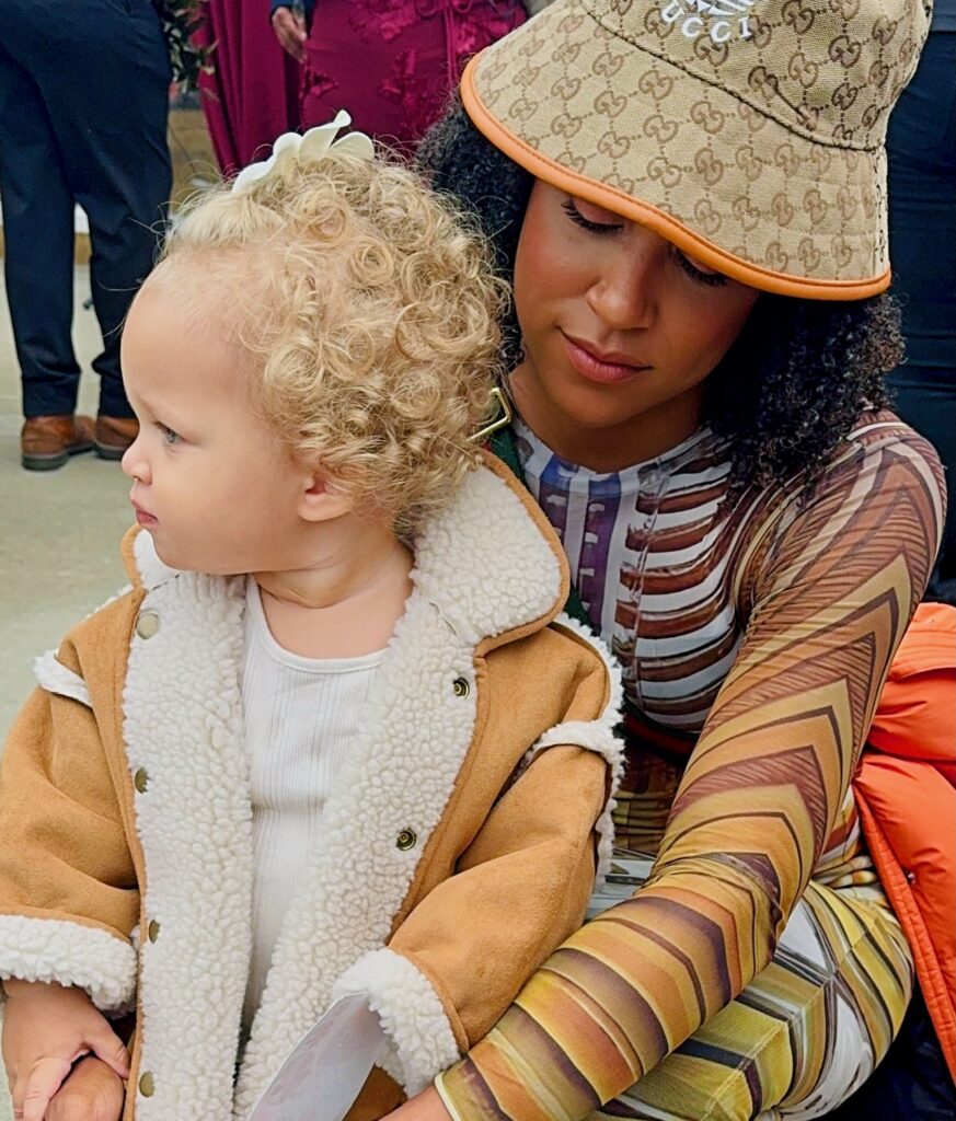 Troy Mullins hits on the ground and holds her daughter, Dylan.