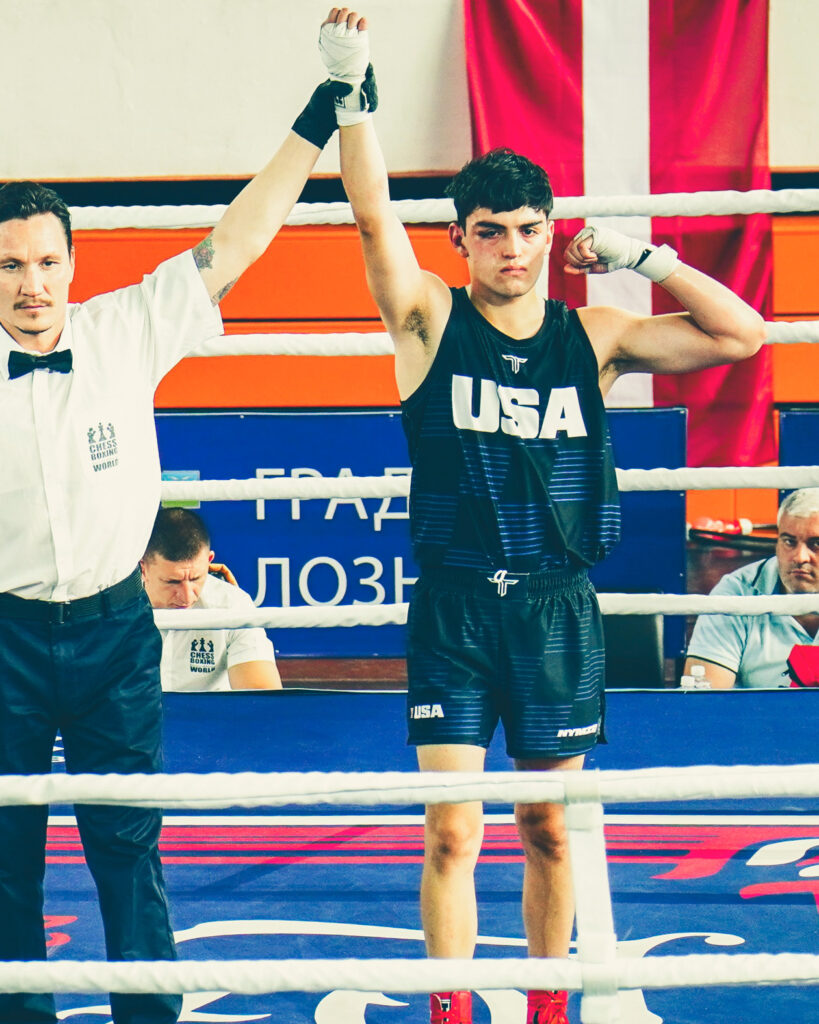 Will MacLeod in the ring at the chessboxing world championships with the referee holding his hand up to declare him the winner.