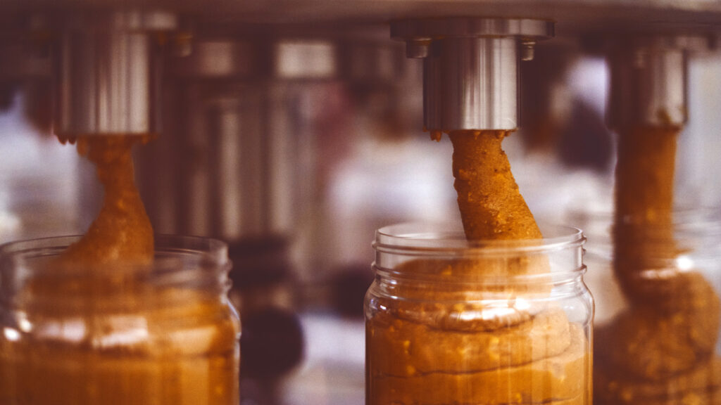 jars are filled with peanut butter on the assembly line at the Teddie factory