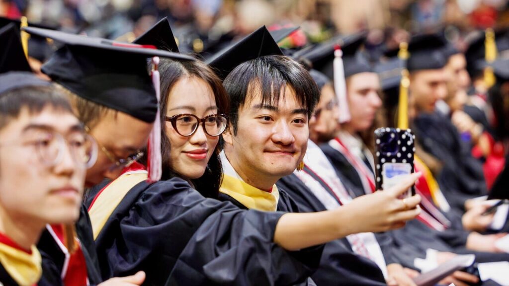 Students take a selfie during the December 2025 recognition ceremony in Barton Hall