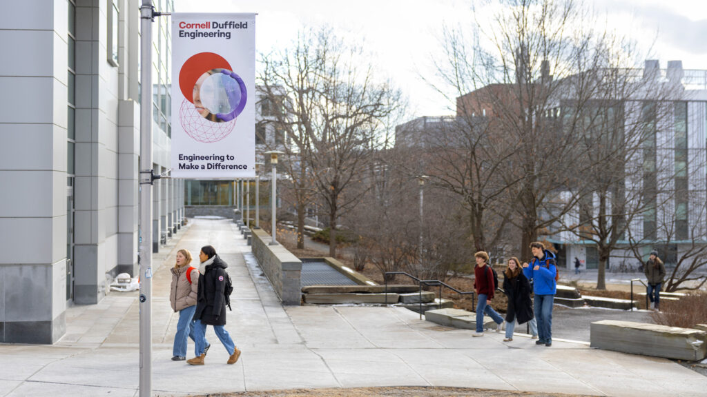 The outside of Duffield Hall with a new light pole banner that says Cornell Duffield Engineering.