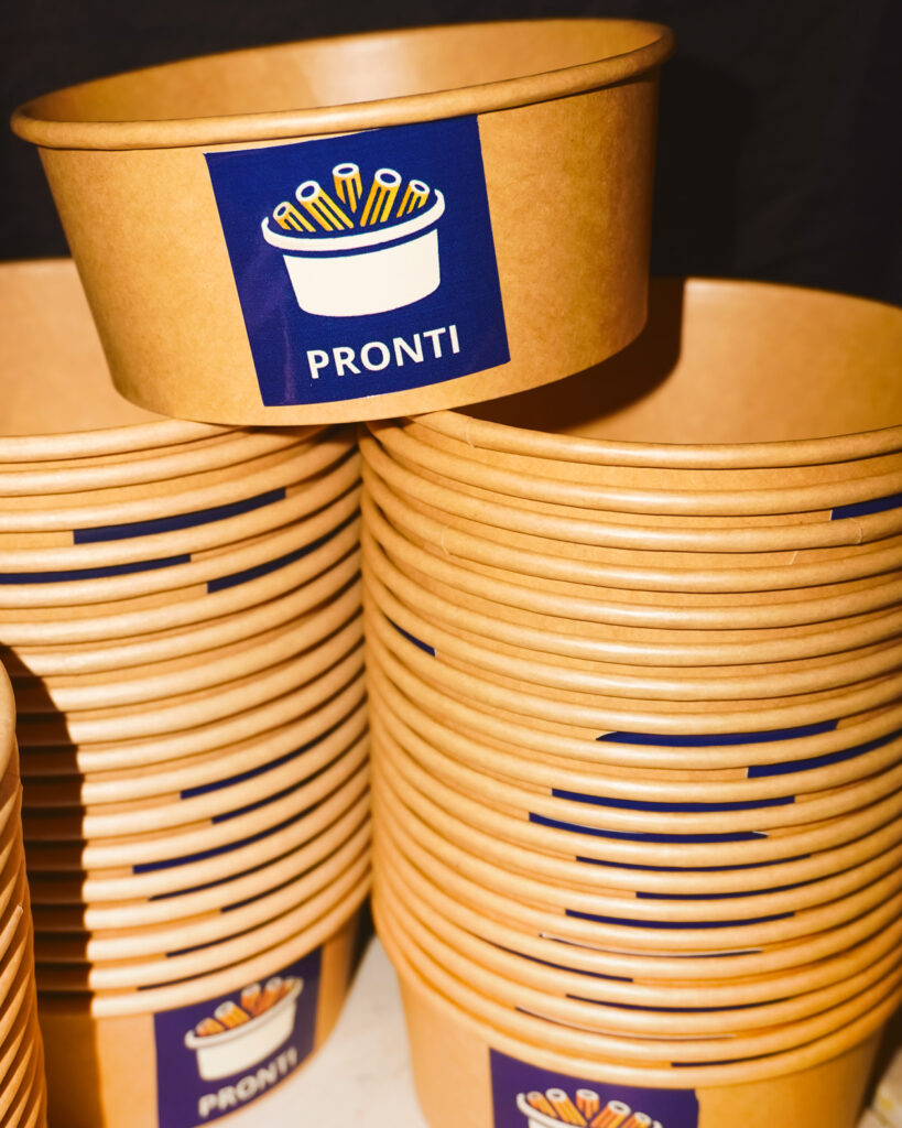 Pronti Pasta branded to-go bowls in stacks.