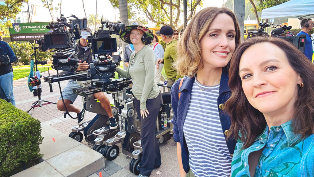Carla Gallo and Rose Byrne smile for a selfie in front of the video equipment on set Platonic.