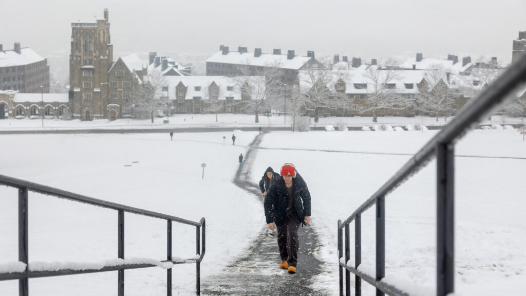 Students walk up libe slope in the winter