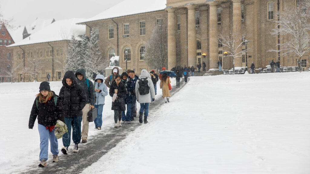 Students walking to class on the arts quad on a snowy day