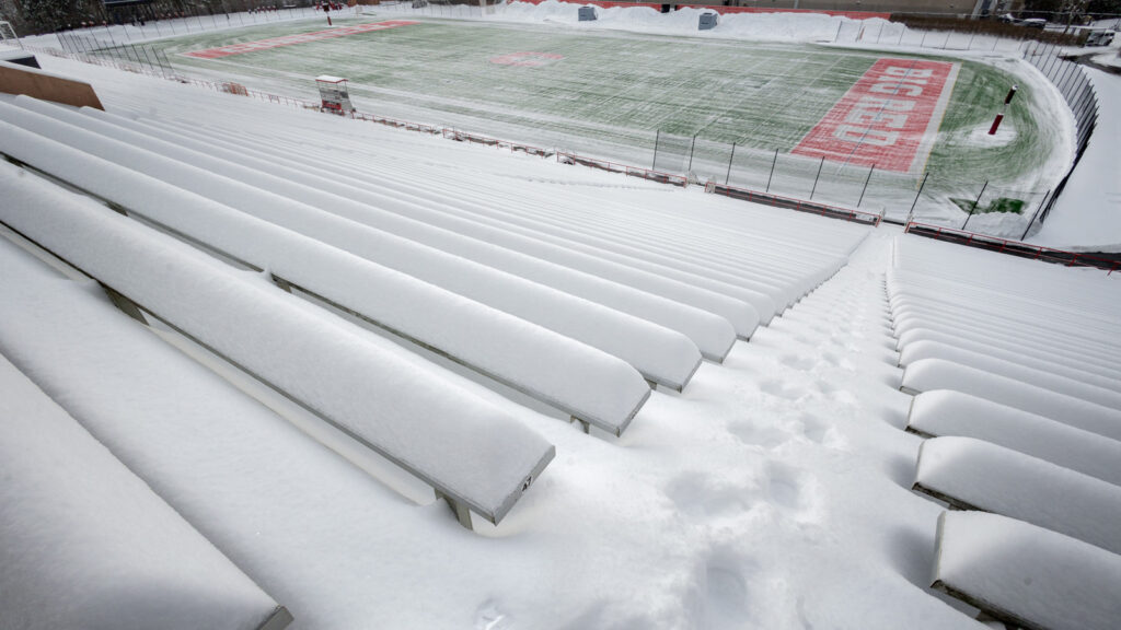 snow covers the outdoor stadium seats at Schoellkopf Field in winter