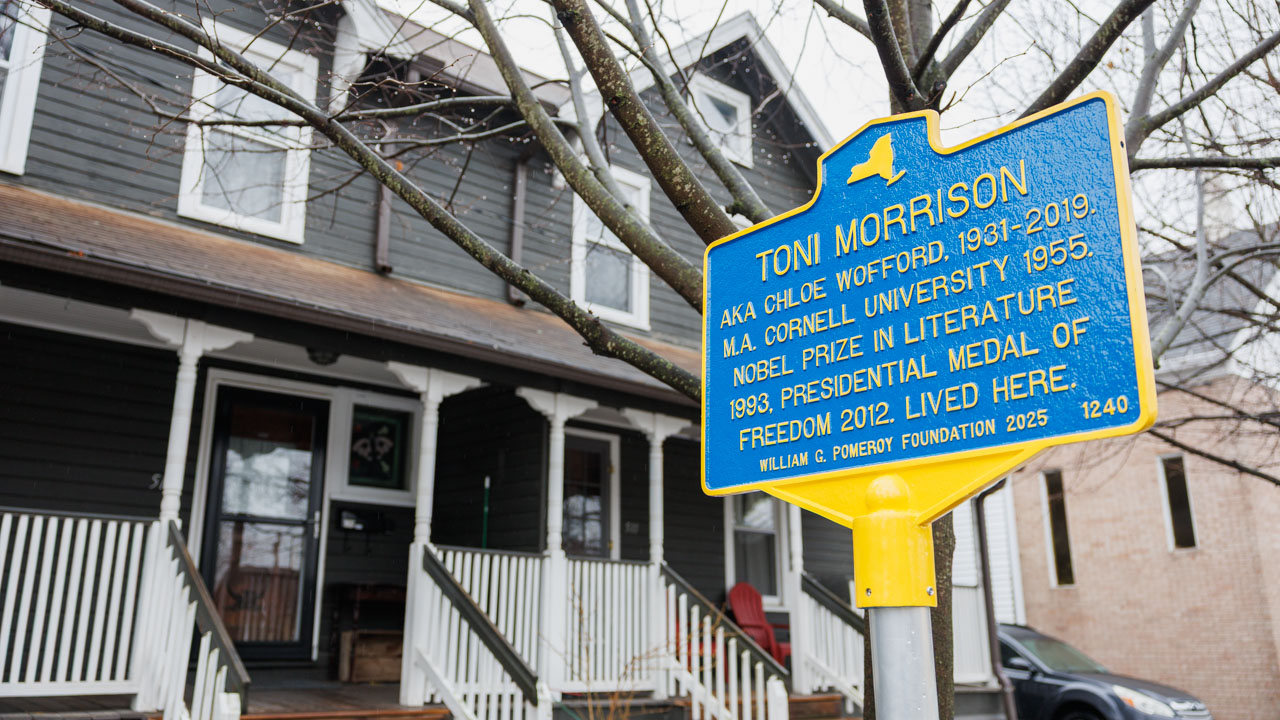 A historic marker outside a residential building that reads: "Toni Morrison AKA Chloe Wofford, 1931–2019. M.A. Cornell University 1955. Nobel Prize in Literature, 1993. Presidential Medal of Freedom, 2012. Lived here."