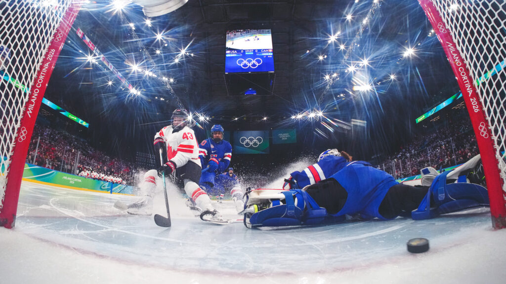 MILAN, ITALY - FEBRUARY 19: (EDITOR’S NOTE: Image was captured using a remote netcam.) Kristin O'Neill #43 of Team Canada scores a goal against Laila Edwards #10 and Aerin Frankel #31 of Team United States during the Women's Gold Medal match between the United States and Canada on day 13 of the Milano Cortina 2026 Winter Olympic games at Milano Santagiulia Ice Hockey Arena on February 19, 2026 in Milan, Italy. (Photo by David W Cerny - Pool/Getty Images)