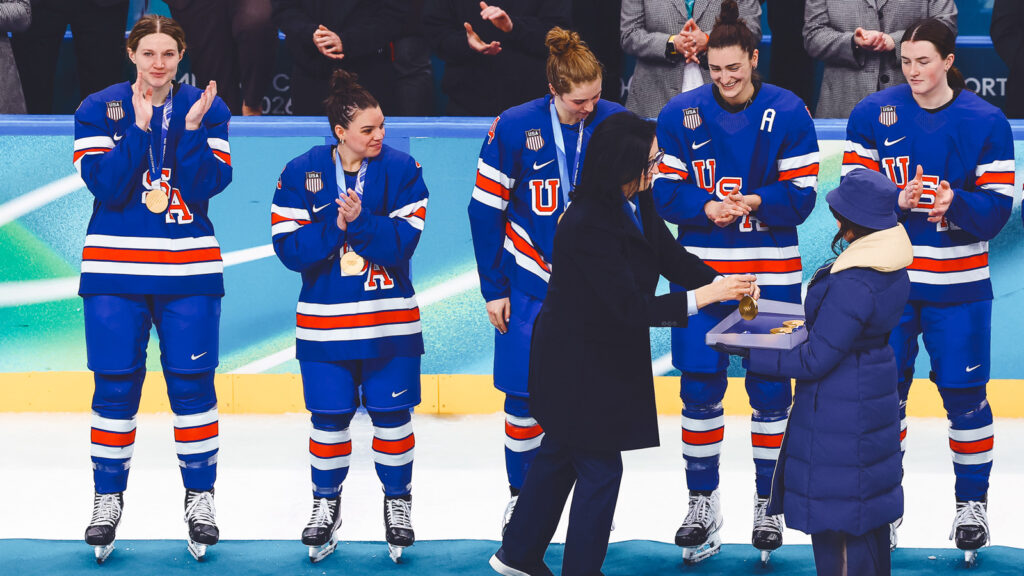 MILAN, ITALY - FEBRUARY 19: Gold medalists Lee Stecklein #2, Cayla Barnes #3, Caroline Harvey #4, Megan Keller #5 and Rory Guilday #6 of Team United States are presented the medals during the medal ceremony for the Ice Hockey Women following during the Women's Gold Medal match between the United States and Canada on day thirteen of the Milano Cortina 2026 Winter Olympic games at Milano Santagiulia Ice Hockey Arena on February 19, 2026 in Milan, Italy. (Photo by Sarah Stier/Getty Images)