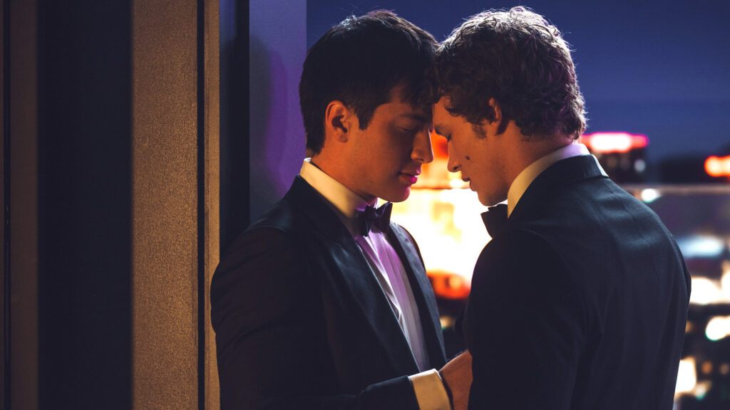 Shane and Ilya, wearing tuxedos, touch their foreheads together in a scene from "Heated Rivalry"