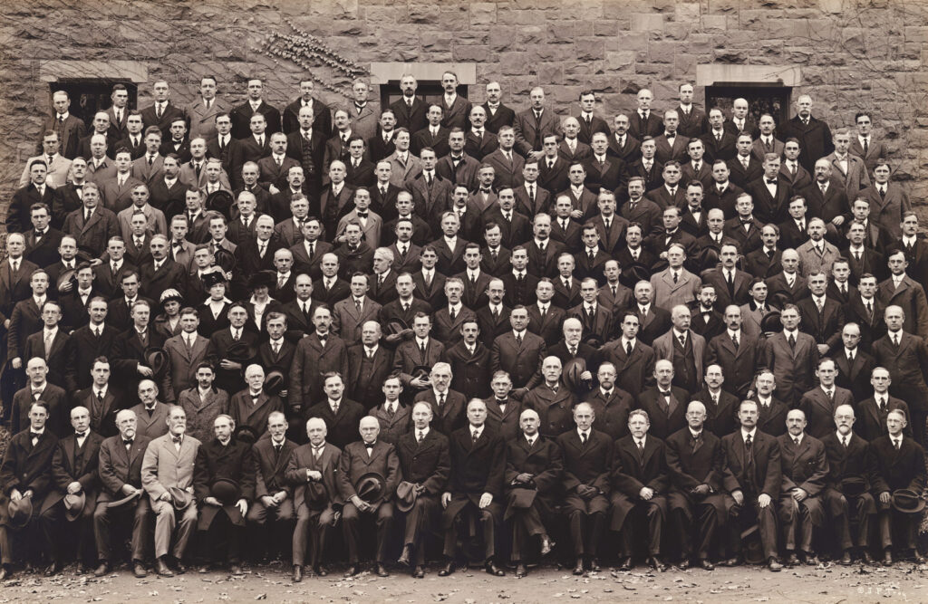 A group of Cornell University faculty in 1916; it is entirely male except for three women.