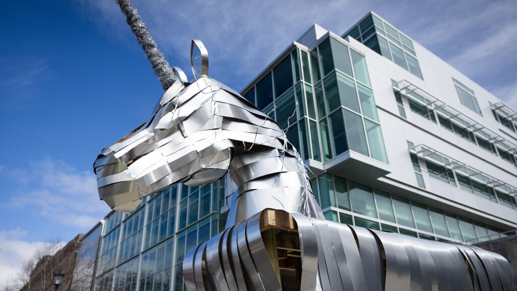 A silver, shiny unicorn in front of the Physical Sciences Building during Dragon Day 2026