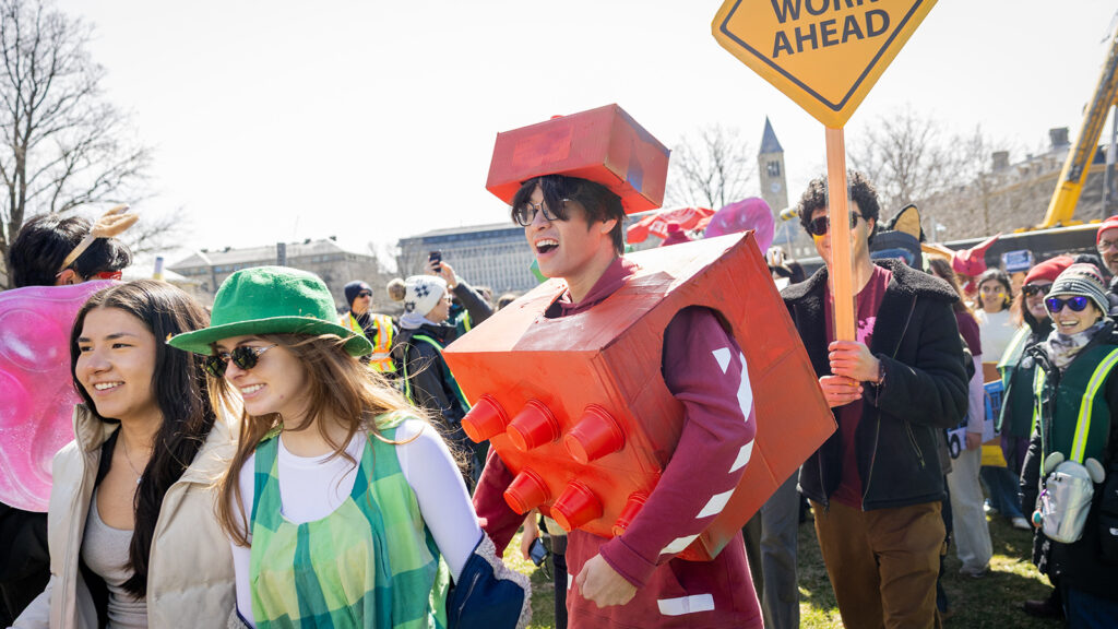 Students at dragon day, with one dressed as a red Lego