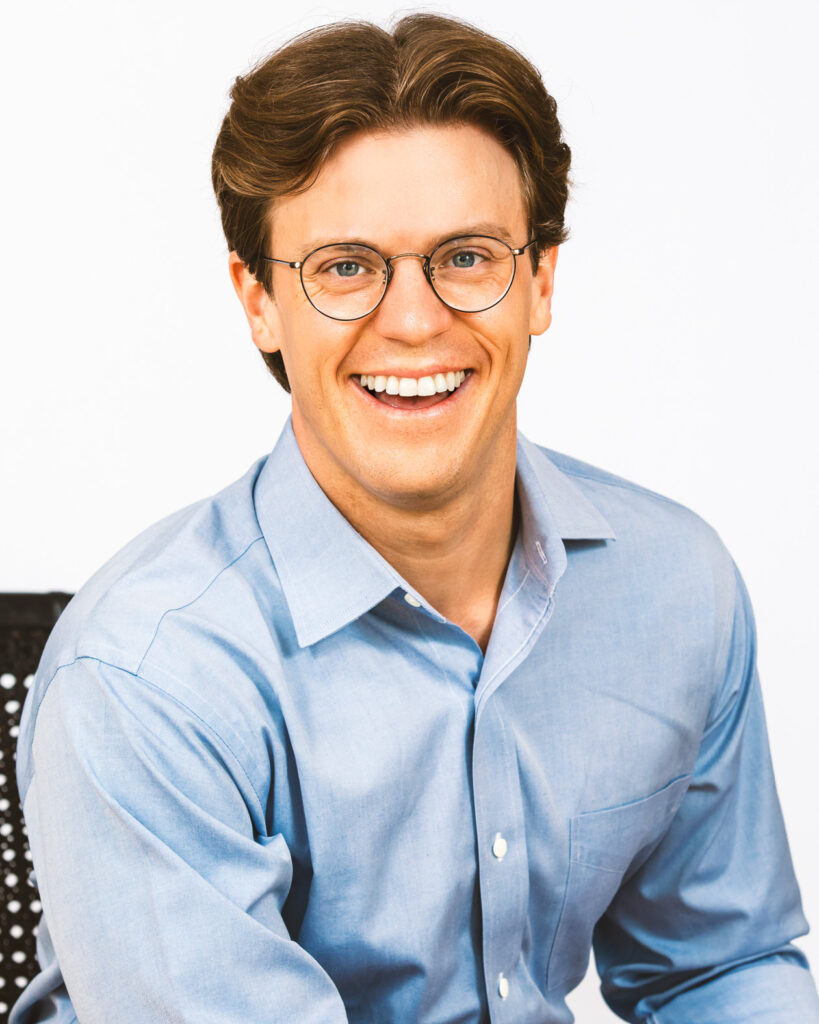 Adam Wolford wearing a blue Oxford shirt