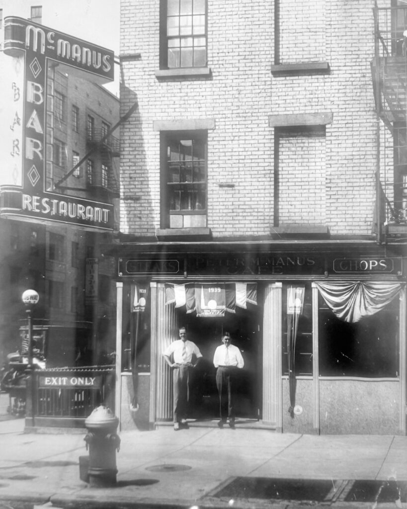 Exterior of the McManus Café in 1939, including a large marquee sign that long graced the building's exterior until renovations to the adjacent subway station necessitated its removal.