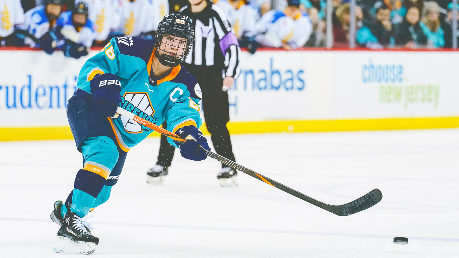 Micah Zandee-Hart skates with the puck during a PWHL game for the New York Sirens against the Toronto Sceptres.