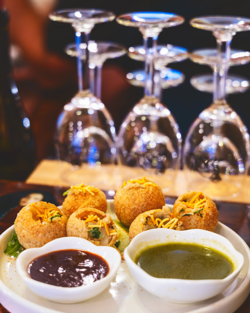 Cheeni's phucka dish with wine glasses in the background