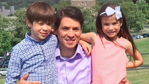 Juan Uribe ’96 with his two children on campus in 1996