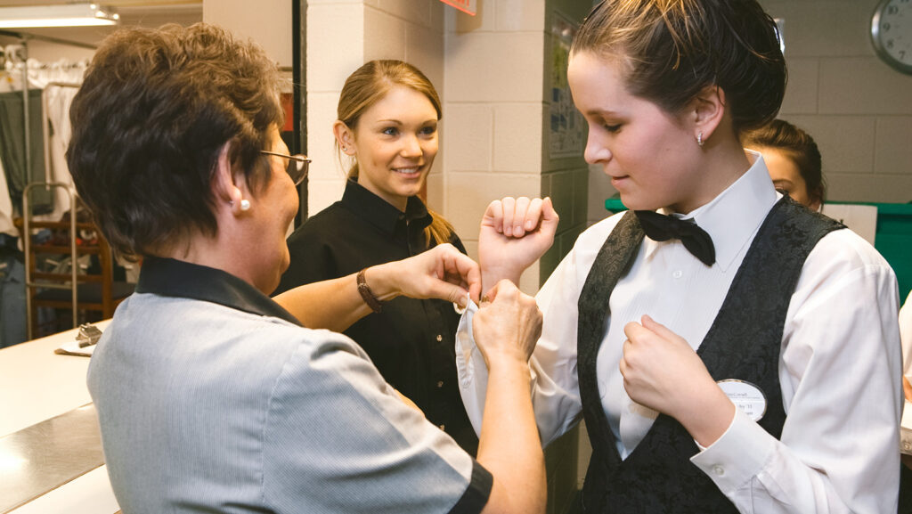 A Hotel school student has her sleeves fastened in preparation for an event at Hotel Ezra Cornell 2008