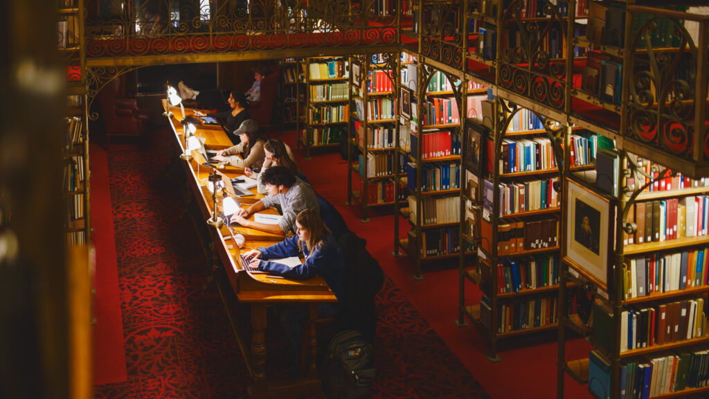 Students studying at a long table in the A.D. White Library
