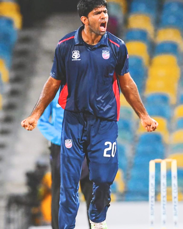 Saurabh Netravalkar celebrates on the field in his Team USA jersey.