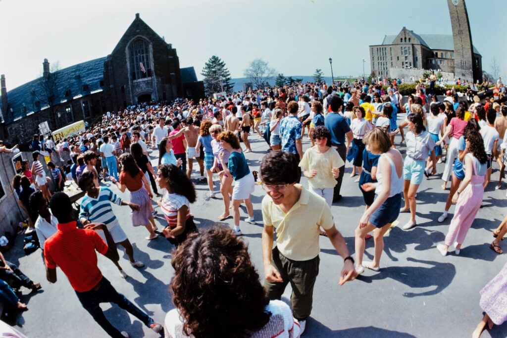 students dance outdoors between Willard Straight Hall and the Cornell Store at Springfest 1984