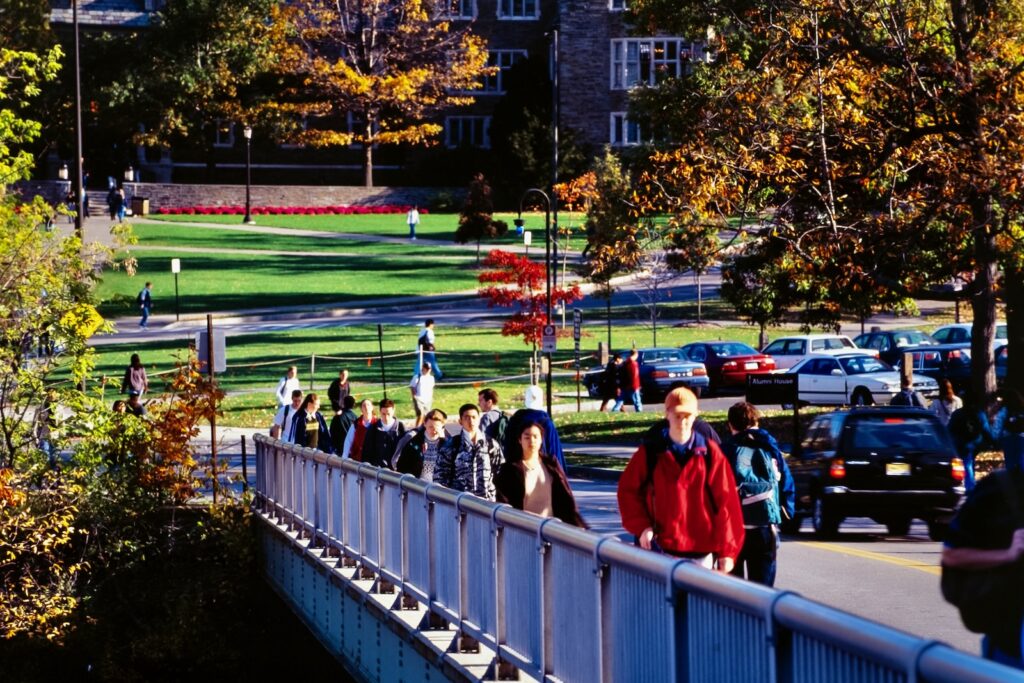 students cross the Thurston Avenue bridge from North Campus in spring 1999