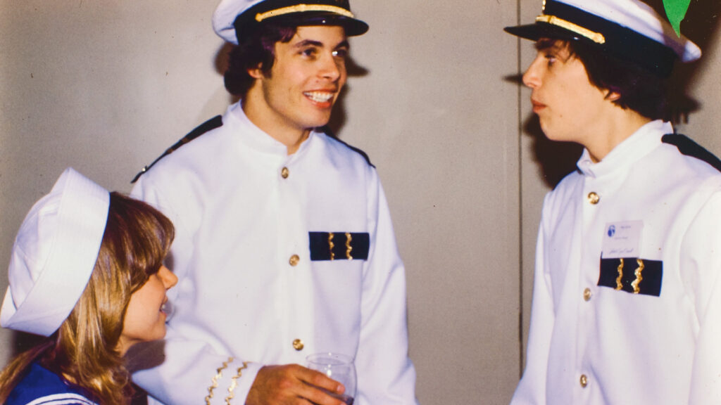 students in nautical dress chat during Hotel Ezra Cornell in 1979
