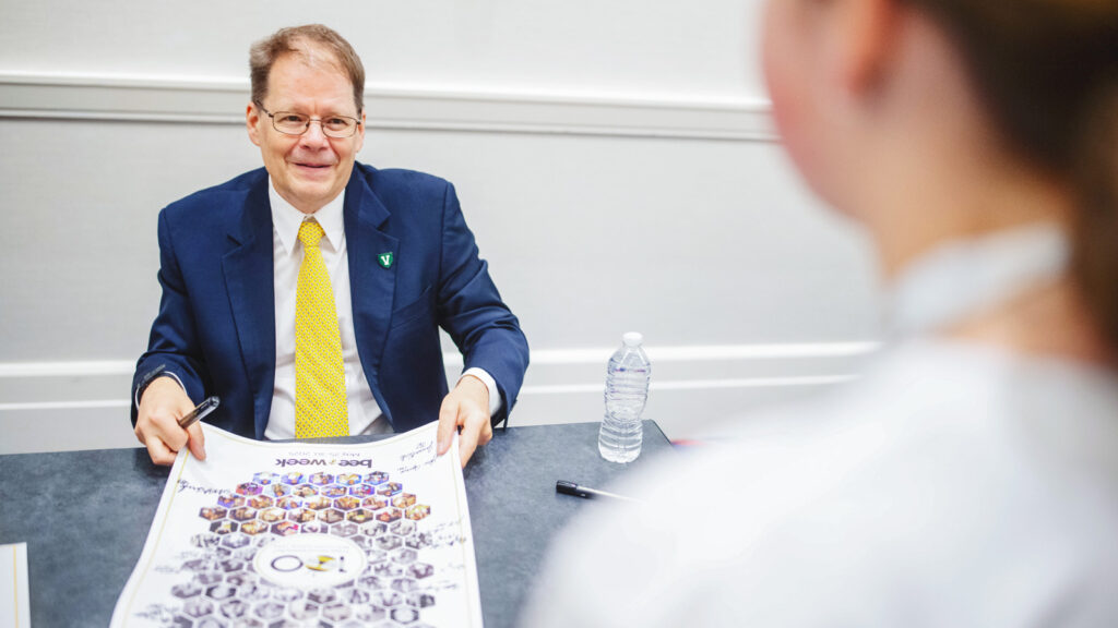 Dr. Jacques Bailly signs an autopgraph at Bee-con during the 2025 Scripps National Spelling Bee on May 29, 2025 in National Harbor, MD.