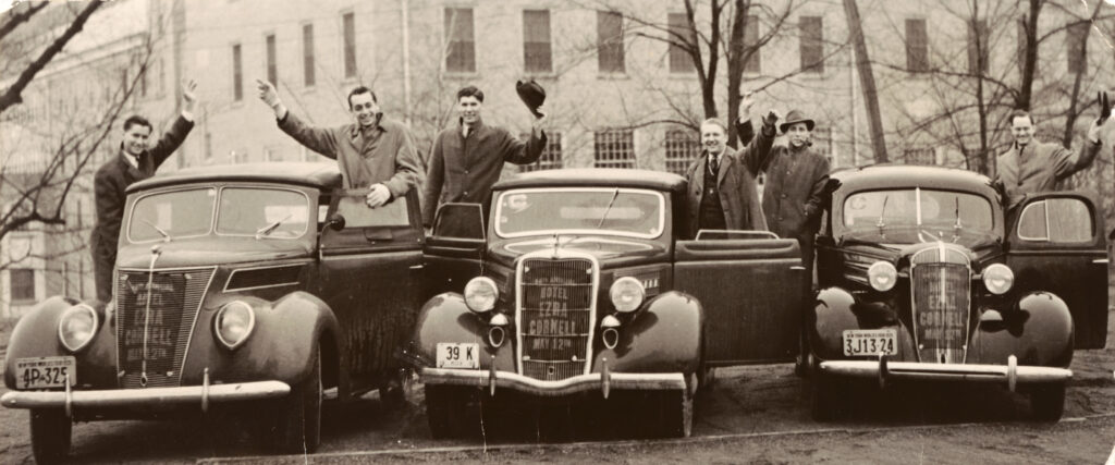 Hotel students wave from three cars with "Hotel Ezra Cornell" in their front grilles for Hotel Ezra Cornell in 1939