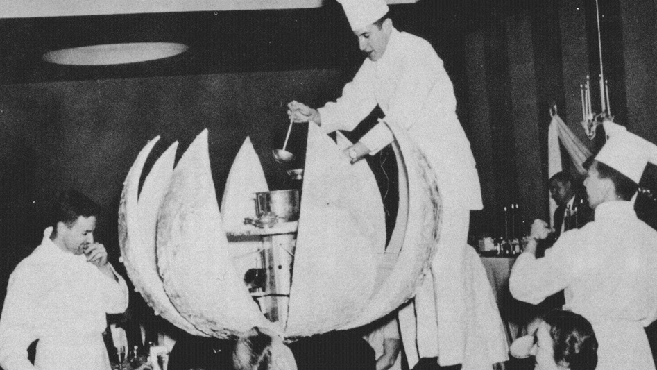 In 1957, a Hotel Ezra Cornell gala dinner included Chef Daniel Clifton serving dessert from a giant globe of sugar that opened to reveal an elaborate tartelette aux cerises flambées—a French tart featuring cherries that have been set aflame; that year's theme was "HEC International"