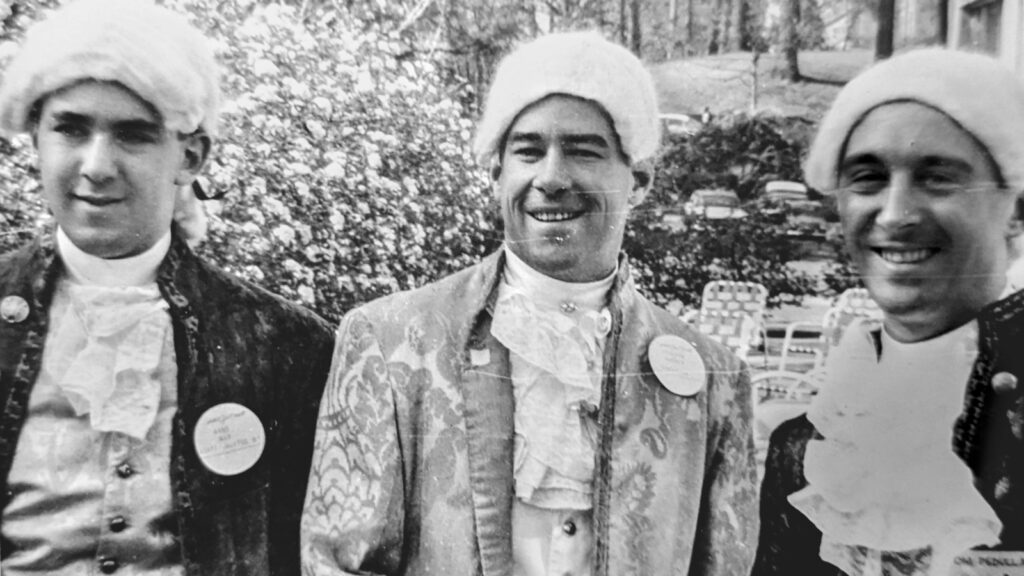 Three participants of the 17th-century-France-themed Hotel Ezra Cornell in 1960 wear white wigs and period costume