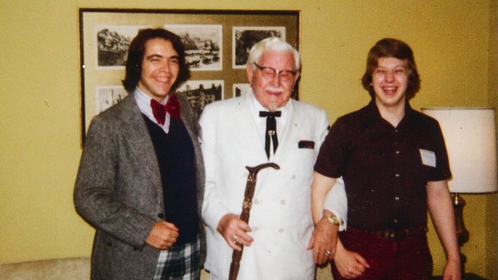 Kentucky Fried Chicken founder Colonel Sanders is shown between two Hotel School students at Hotel Ezra Cornell in 1974