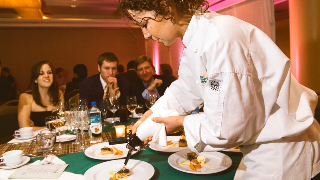 a student preps dishes during Hotel Ezra Cornell in 2006