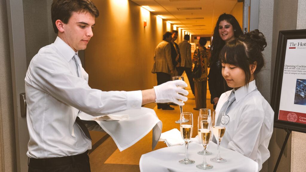 students place champagne glasses for serving at Hotel Ezra Cornell in 2010