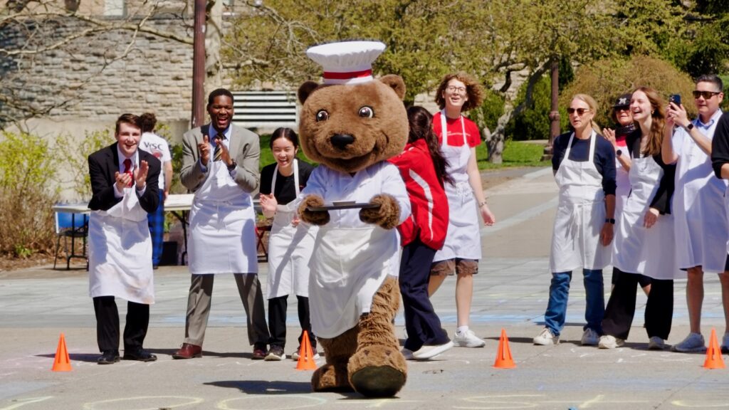 Touchdown, decked out in chef's hat and apron, takes a turn carrying a tray of soup during the Server Derby during Hotel Ezra Cornell 2026