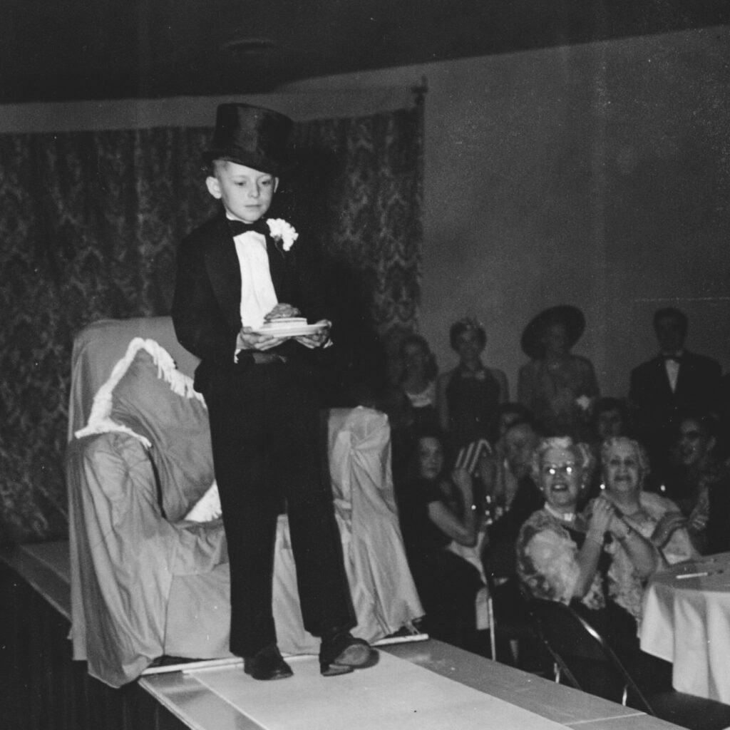 At age 7, Thomas Lattin ’66, the son of a hotel professor, carries a dessert to present to Alice Statler at Hotel Ezra Cornell in 1953; 13 years later, he served as the managing director for his own Hotel Ezra Cornell in 1966