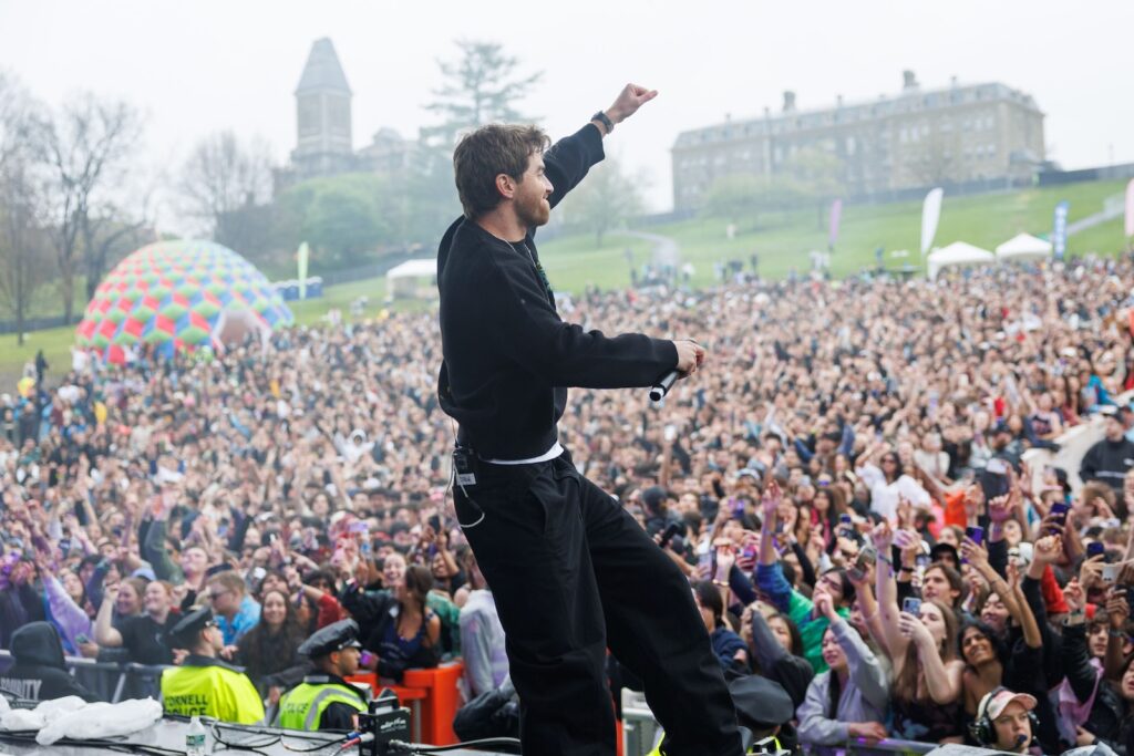 A man performs in front of the Slope Day crowd