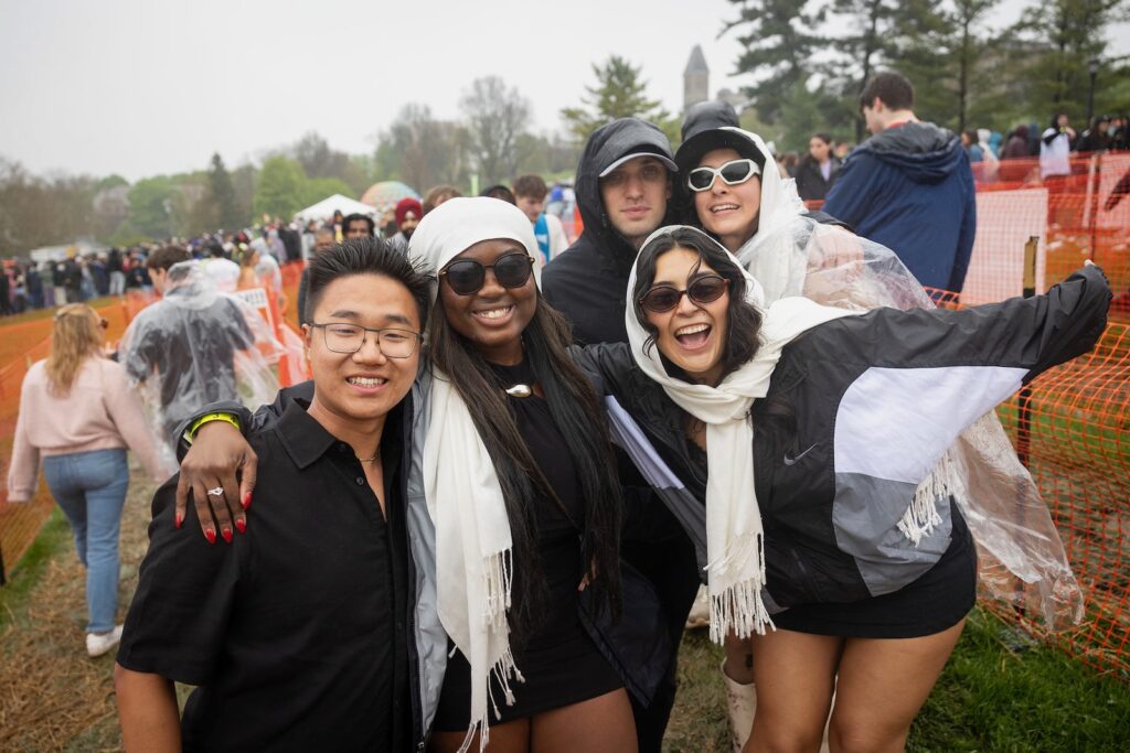 Five smiling students pose on the Slope