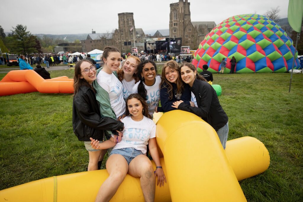 Six female students pose on a yellow inflatable