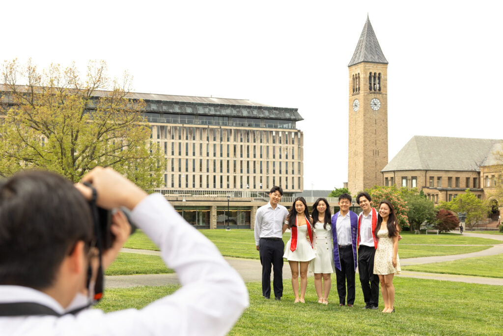 Six students smile together for a photo on the Arts Quad.