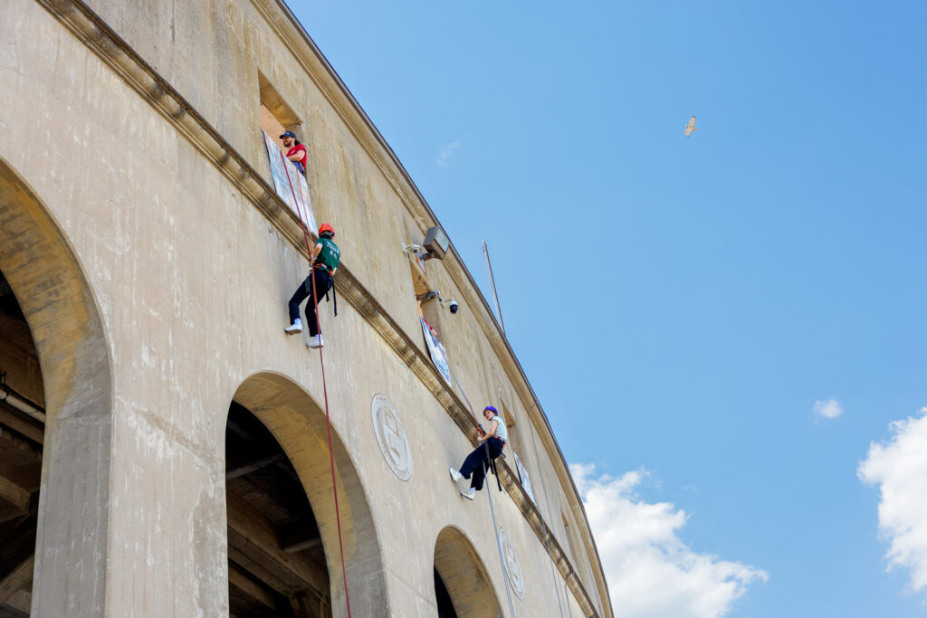 Two people rappelling on Schoellkopf Field stadium during Senior Days 2026.