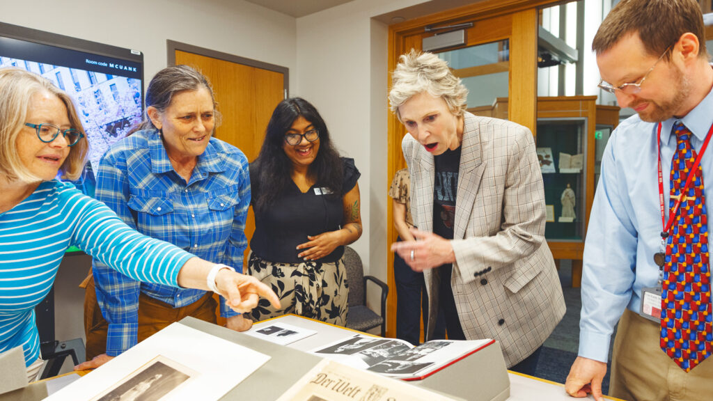 Jane Lynch visits Kroch Library and looks at herself in old yearbooks