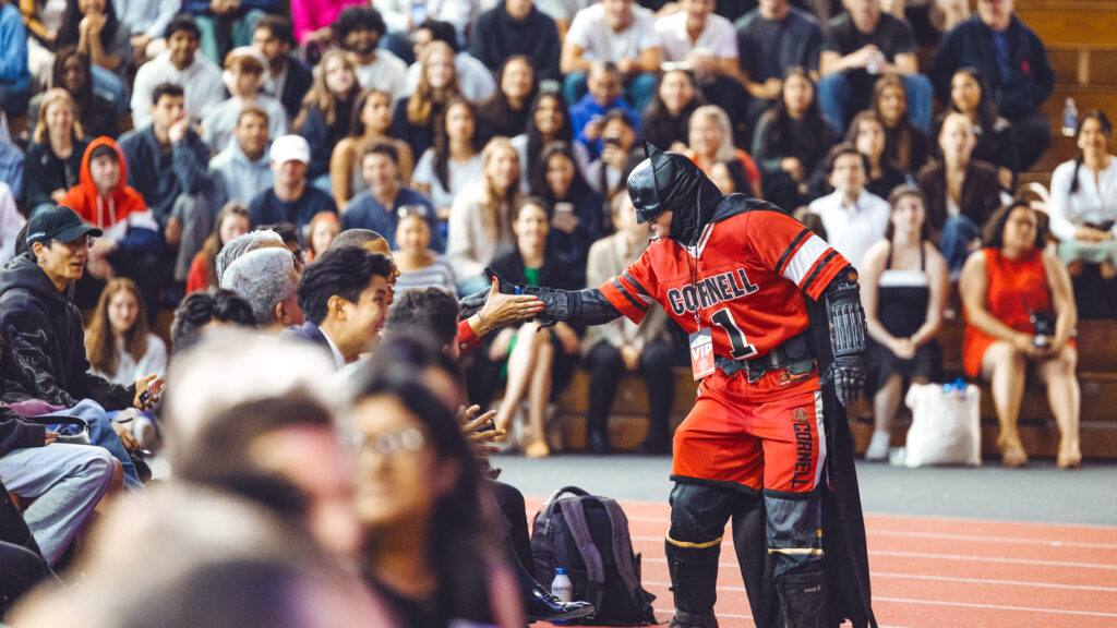 A student dressed as Batman greets the crowd