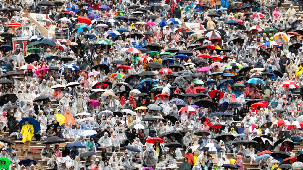 A sea of umbrellas and people in clear ponchos